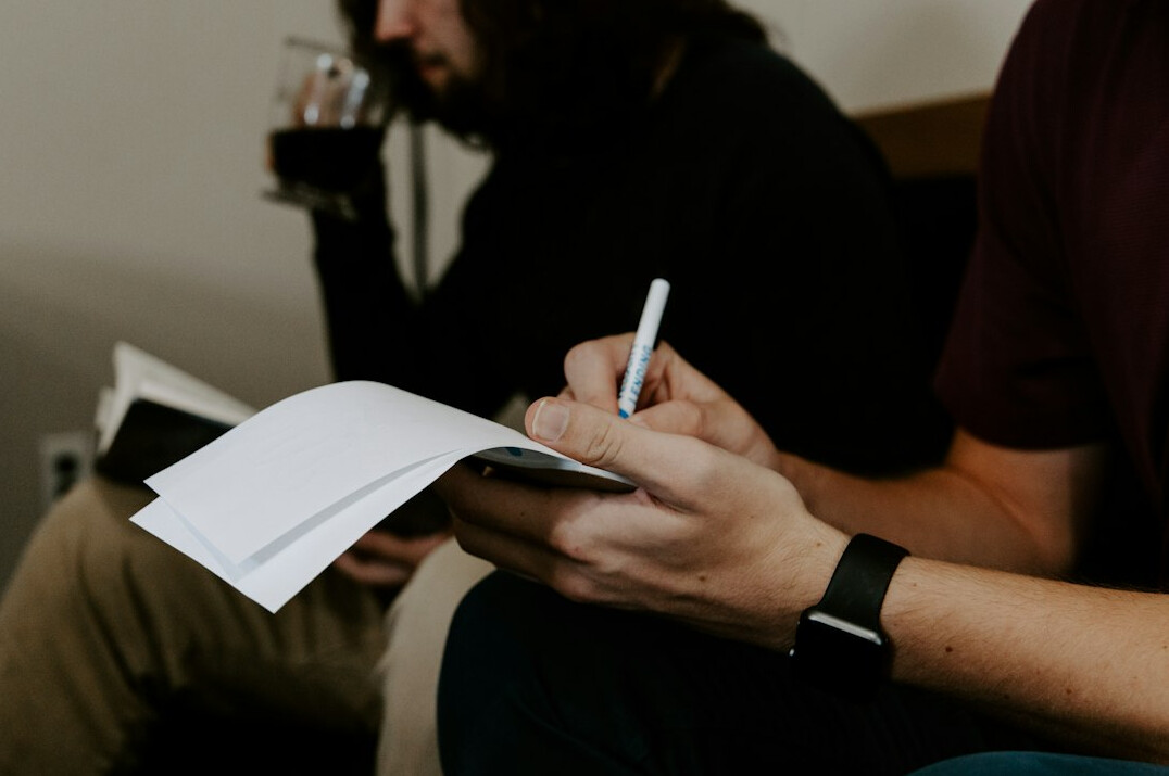 person writing budget list