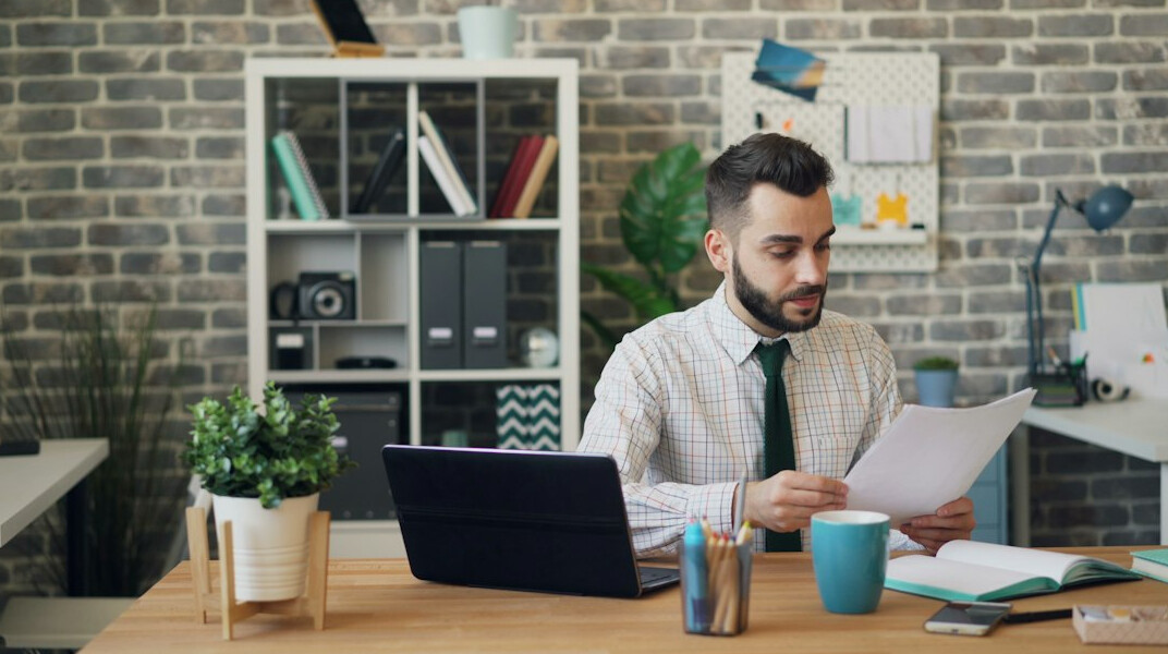 person reviewing bills at desk